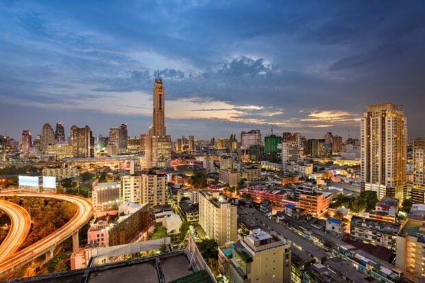 Evening view of Bangkok skyline with tall buildings and city lights
