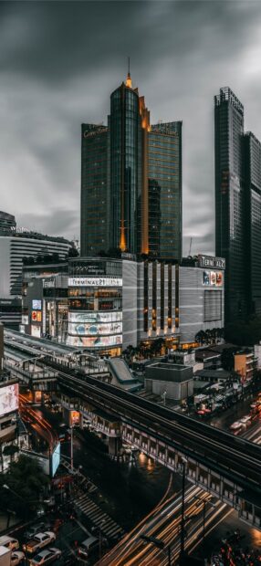 Terminal 21 mall with Bangkok skyline viewed from above during rainy evening