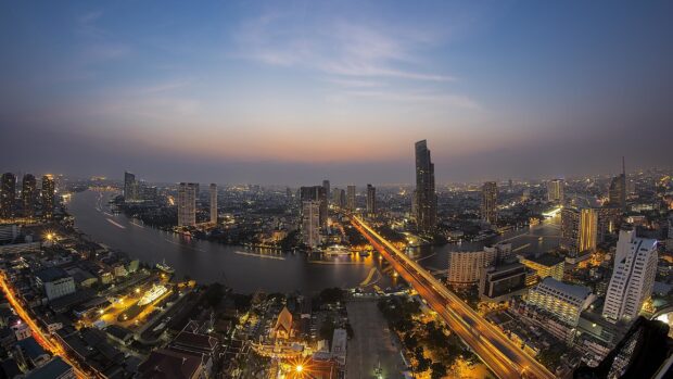 Beautiful cityscape of Bangkok at dusk with a river and illuminated buildings