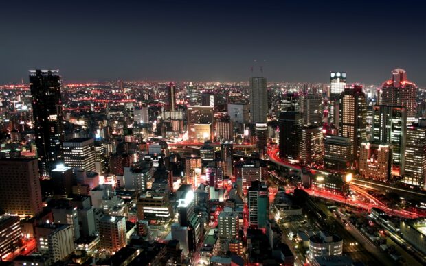 Night cityscape of Bangkok with illuminated buildings and busy streets at 2k resolution
