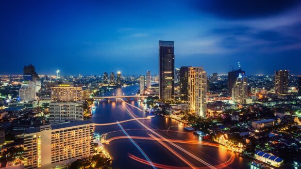Night cityscape with Bangkok skyline and river reflection in Bangkok