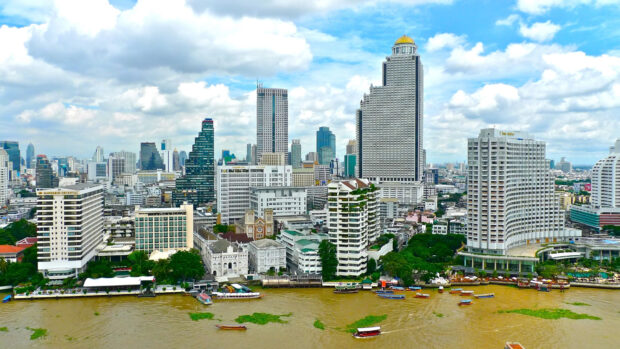 Bangkok cityscape with modern buildings along the river in a clear sky