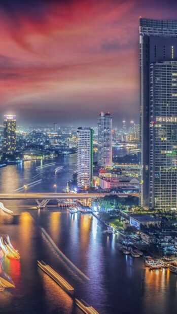 Evening cityscape with Bangkok skyline and river view at sunset