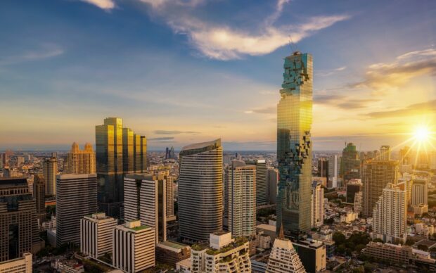 Modern architecture in Bangkok cityscape with dramatic sunset sky