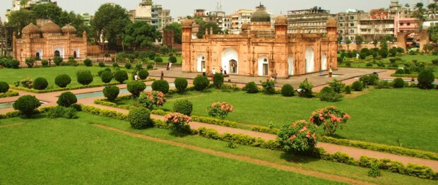 Ancient Bangladesh architecture with green gardens and people walking around