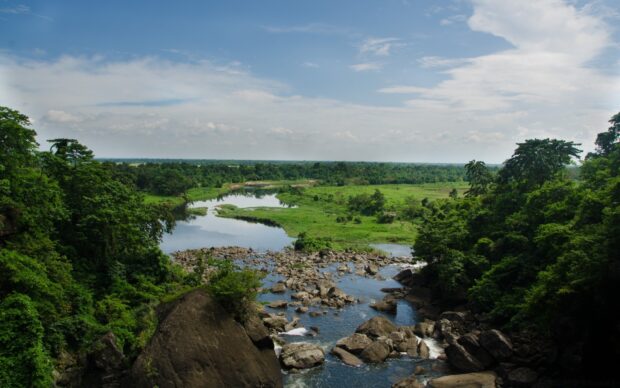 A peaceful river flowing through lush greenery in Bangladesh landscape