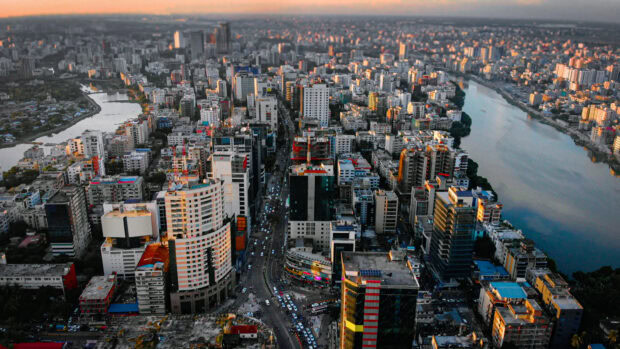Aerial view of Bangladesh cityscape showing buildings and river at sunset