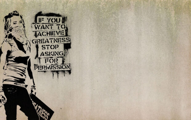 A Banksy stencil of a masked woman holding a sign with the word greatness on a concrete wall