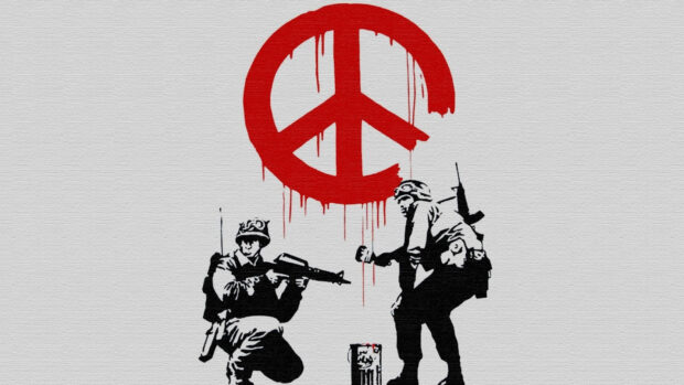 Soldiers in Banksy graffiti painting creating a red peace symbol on a wall