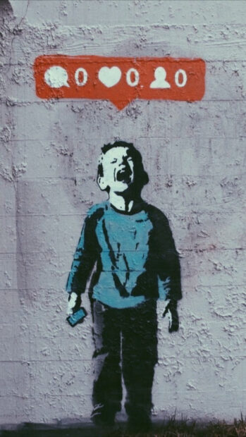 Banksy graffiti of a crying boy holding a phone with social media icons above