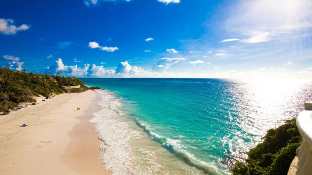 A beautiful Barbados beach with clear turquoise water and a sunny blue sky