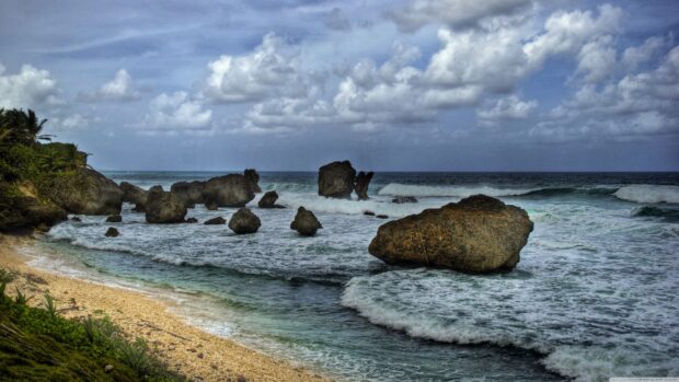 Rocky coastline with turquoise water and clouds at Barbados beach