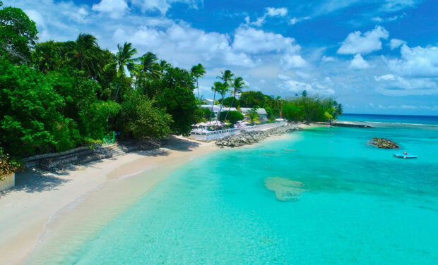 Beautiful turquoise sea and lush greenery of Barbados coastline on a sunny day
