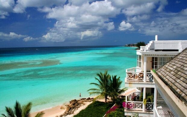 Stunning Barbados coastline with white sandy beach and turquoise water under a cloudy sky
