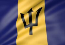 The Barbados flag with its distinctive trident symbol waving in the wind