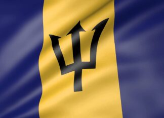 The Barbados flag with its distinctive trident symbol waving in the wind