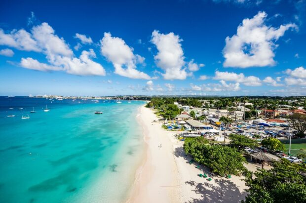 A beautiful coastline of Barbados with turquoise water and white sandy beach under a clear blue sky