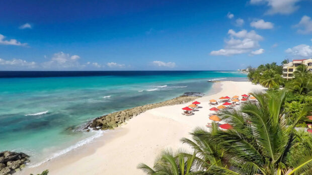Beautiful Barbados coastline with clear turquoise water and sandy beach under blue sky