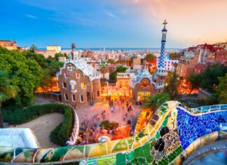 Gaudi style architecture and colorful mosaic tiles in Barcelona cityscape at sunset view