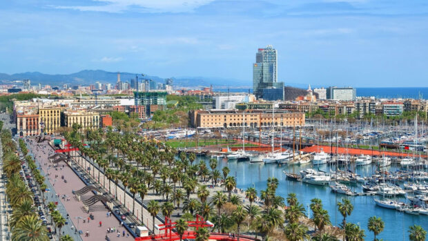 A panoramic view of Barcelona city with harbor and buildings in the background