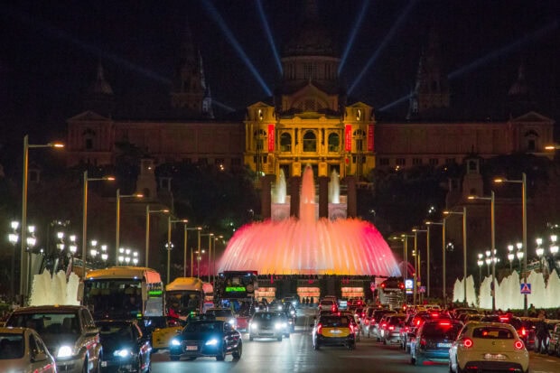 The Magic Fountain illuminated at night with the National Art Museum in Barcelona City