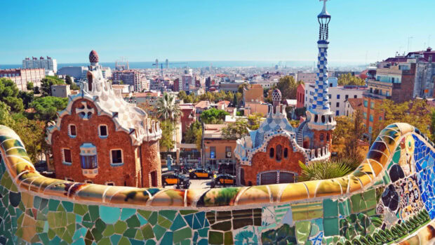 Unique Gaudi architecture in Barcelona city with colorful mosaic tiles and cityscape view