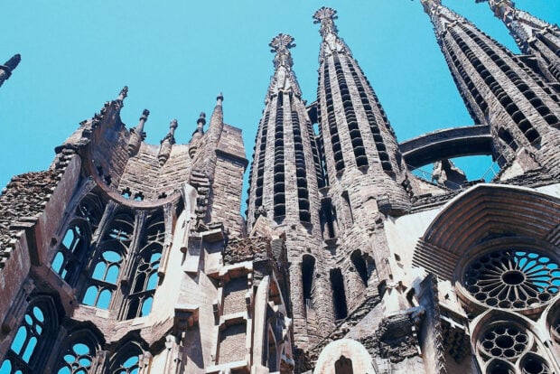 The intricate architecture of Barcelona city cathedral towers under clear blue sky