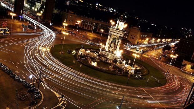 Nighttime traffic trails and the Columbus monument in Barcelona city