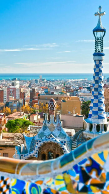 Vibrant mosaic architecture in Barcelona cityscape with colorful tiles and clear sky