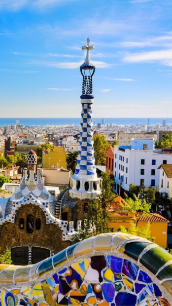 Gaudi architecture is a unique landmark in Barcelona cityscape with mosaic tiles