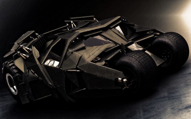 The Batmobile is shown in a detailed close up with heavy armor and rugged tires