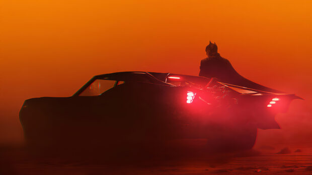Batmobile parked with Batman standing nearby at sunset in high quality 4K