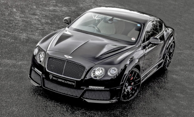 A sleek black Bentley Continental car parked on wet asphalt showcasing luxury and performance