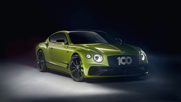A green Bentley Continental showcasing sleek design and luxury features in a studio setting