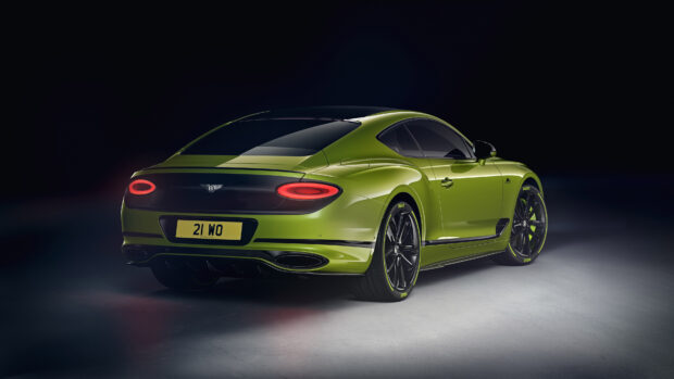 Green Bentley Continental car rear view in a dark studio setting with glowing taillights