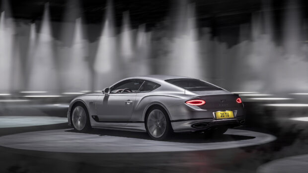 Silver Bentley Continental with illuminated taillights on a rotating platform