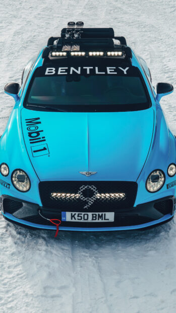 Front view of a Bentley Continental on snowy terrain showing Bentley logo and Mobil 1 decal