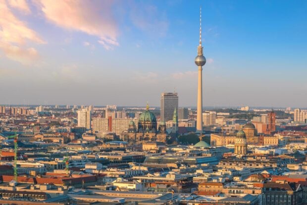 Berlin skyline featuring the TV tower and historic buildings under a partly cloudy sky