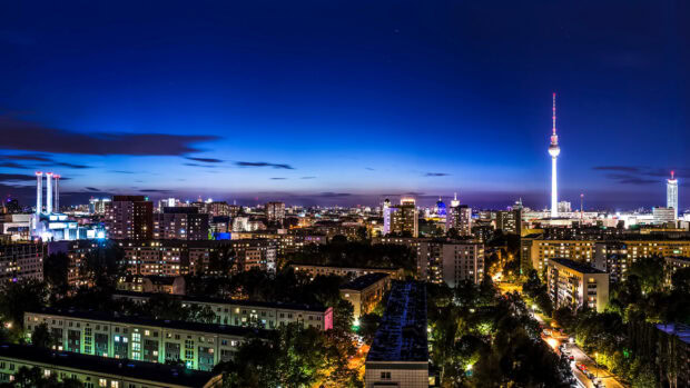 Night view of Berlin skyline with city buildings and TV tower under the blue sky