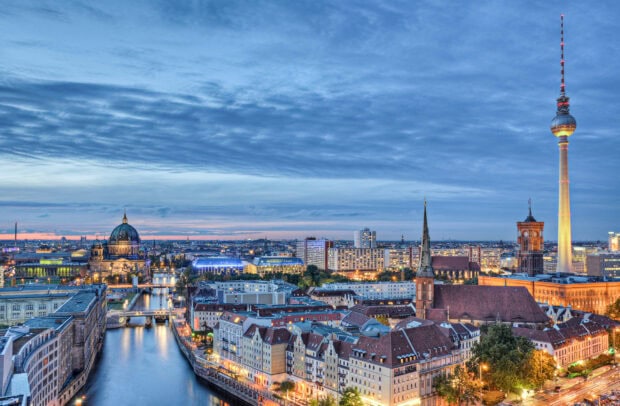 View of Berlin skyline with river and historic buildings at dusk including Berlin Cathedral and TV Tower