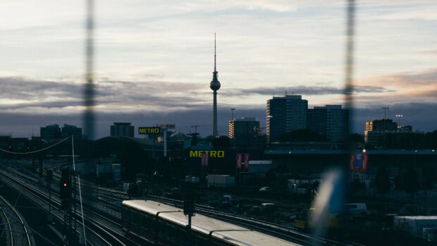 Berlin skyline view with train tracks and metro signs during dusk