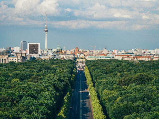 A scenic view of Berlin skyline with trees and the iconic berlin tv tower in the distance