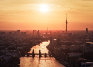 Berlin skyline with river and sunset highlighting the cityscape in warm tones