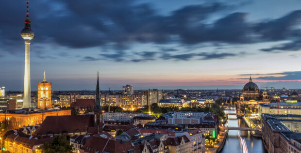Evening view of Berlin skyline with iconic landmarks and river in the background
