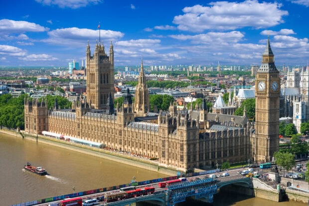 View of the iconic Big Ben clock tower and surrounding buildings along the River Thames in London