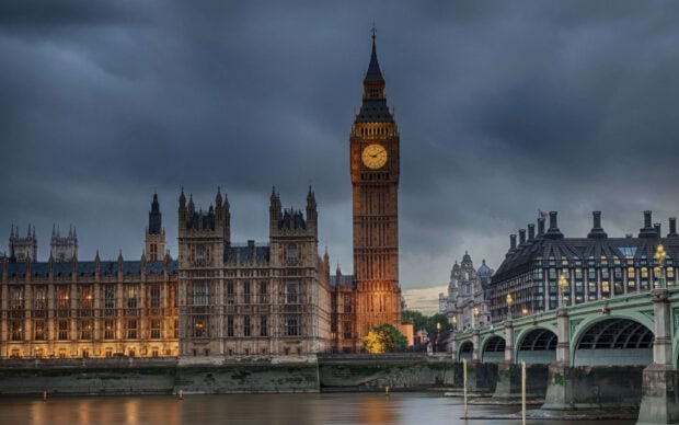 Big Ben tower illuminated at dusk with the Palace of Westminster and Westminster Bridge in London