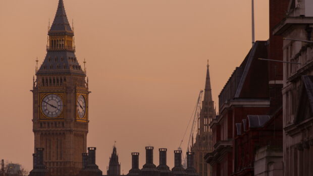 Big Ben clock tower in London cityscape during sunset with clear sky