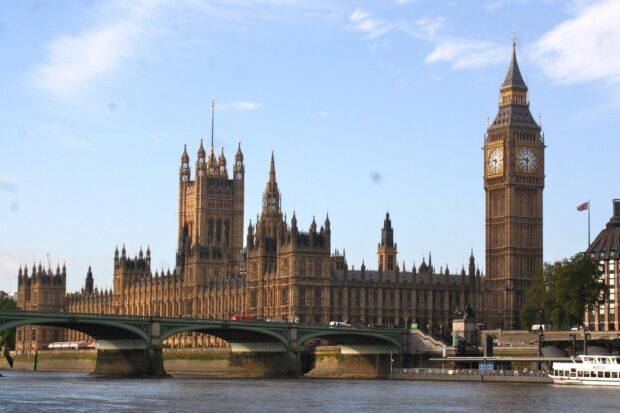 The famous Big Ben clock tower and adjacent buildings along the river Thames in London