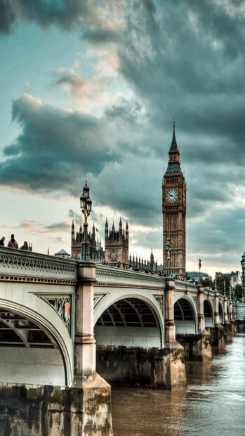 Beautiful Big Ben tower and Westminster Bridge under dramatic sky in London