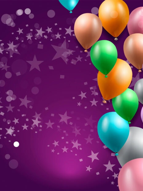 Colorful birthday party balloons floating on a purple background with star decorations